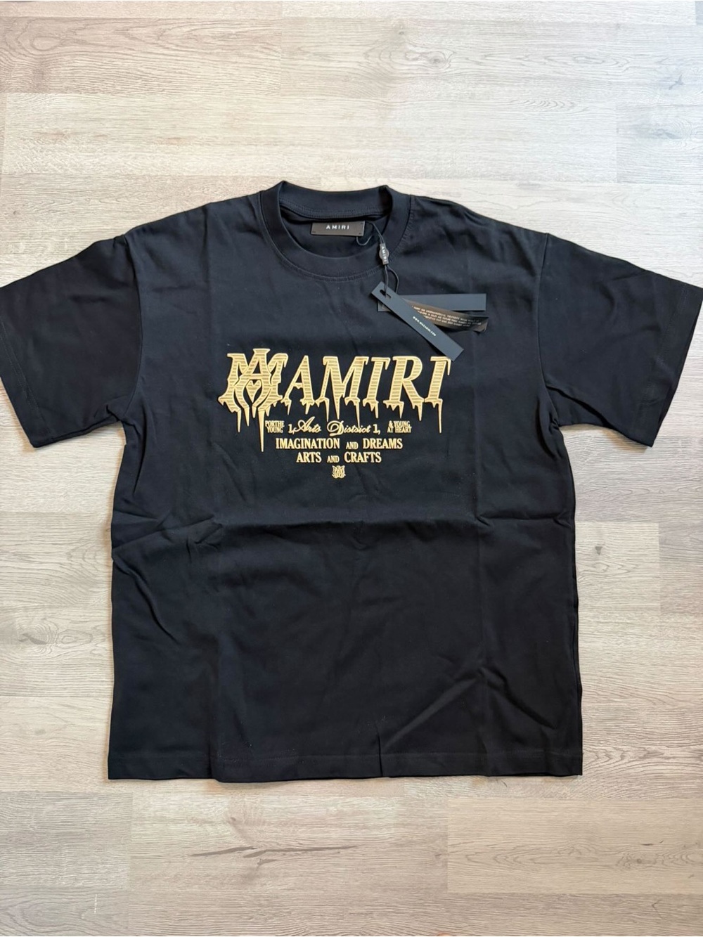 AMIRI Black Tee with Gold Drip Logo and Text